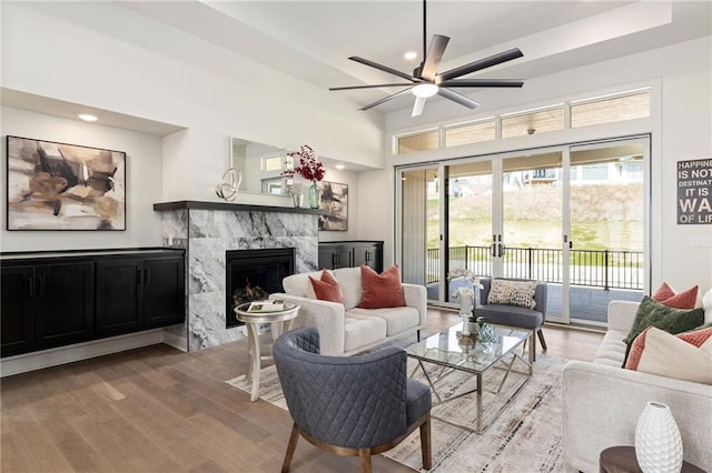 2210 NW Palisades Dr, Riverside, MO 64150 - living area with a premium fireplace, light wood-style floors, ceiling fan, and recessed lighting