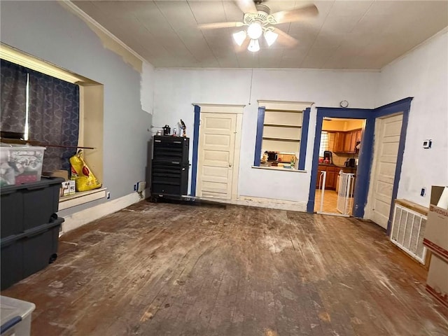 interior space with ceiling fan and dark hardwood / wood-style flooring