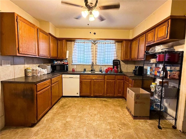 kitchen featuring ceiling fan, dishwasher, backsplash, and sink