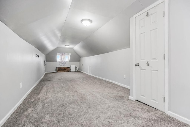 bonus room featuring lofted ceiling and carpet flooring