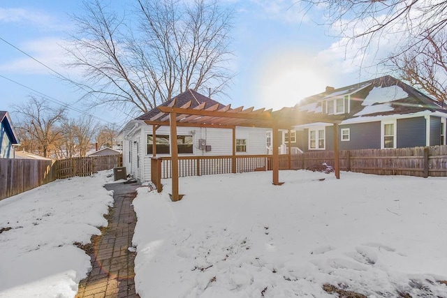 snow covered house featuring a pergola