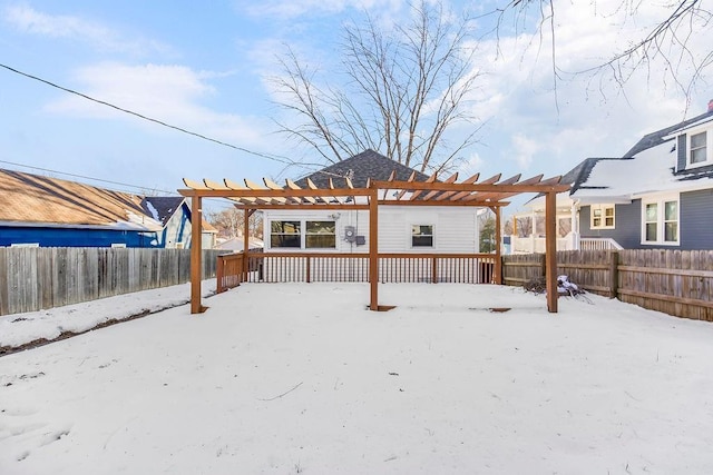 snow covered house featuring a pergola