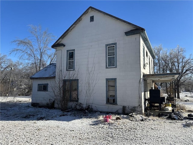 view of snow covered rear of property