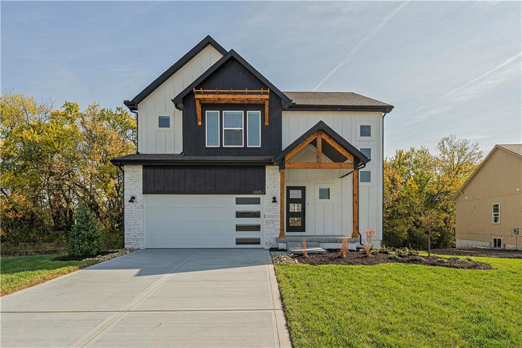 view of front of property with a front yard and a garage