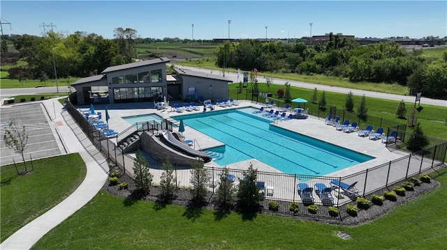 view of swimming pool featuring a lawn and a patio area