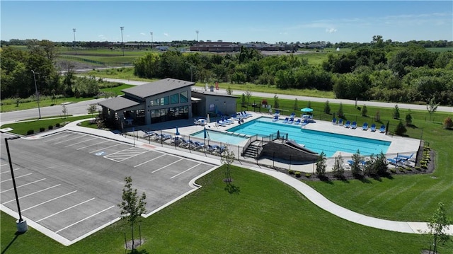 view of swimming pool with a lawn and a patio