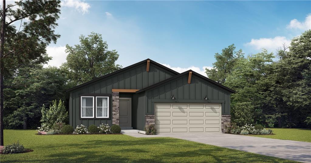 view of front of property featuring a garage and a front lawn