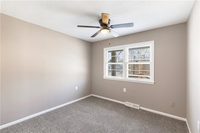 carpeted spare room featuring ceiling fan and a textured ceiling