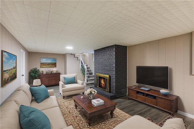 living room with wood-type flooring and a fireplace