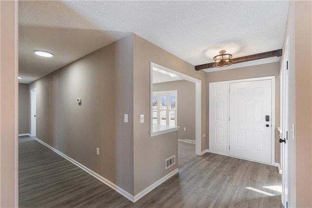 entryway with dark hardwood / wood-style floors and a textured ceiling