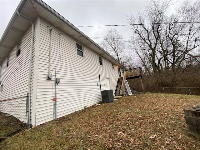 view of home's exterior featuring central AC and a deck