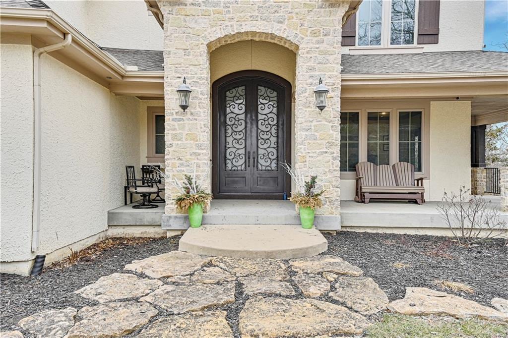 view of exterior entry with a porch