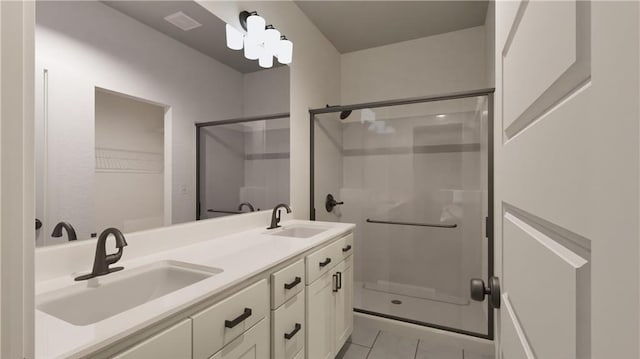 bathroom with vanity, tile patterned floors, and a shower with door