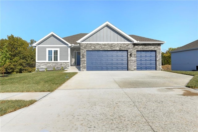 view of front of home with a garage and a front lawn