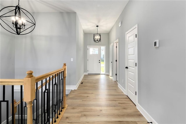 interior space with light wood-type flooring and a notable chandelier