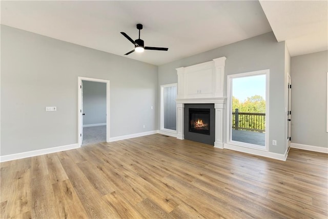 unfurnished living room featuring ceiling fan and light hardwood / wood-style flooring