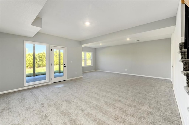 unfurnished living room featuring light carpet