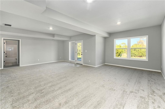 empty room with carpet floors and plenty of natural light