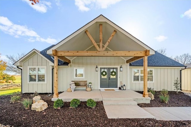 view of front of property with covered porch and french doors