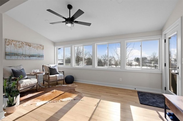 sitting room with lofted ceiling, ceiling fan, and light hardwood / wood-style floors