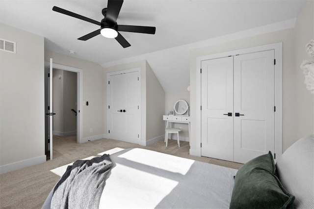 bedroom with ceiling fan, light colored carpet, and vaulted ceiling