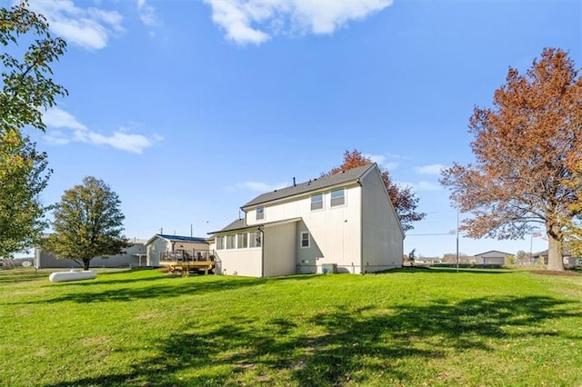 back of property featuring a lawn