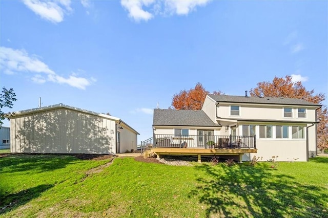 back of house with a wooden deck and a lawn