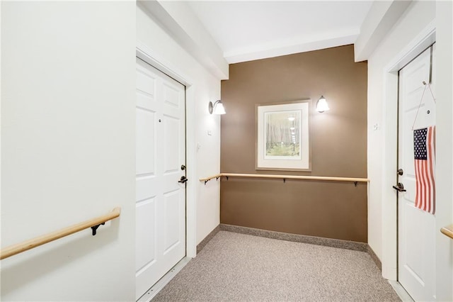 hallway featuring light colored carpet