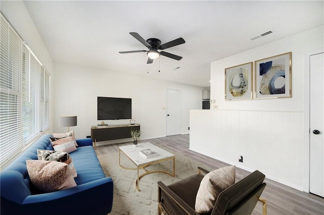 living room with ceiling fan and wood-type flooring