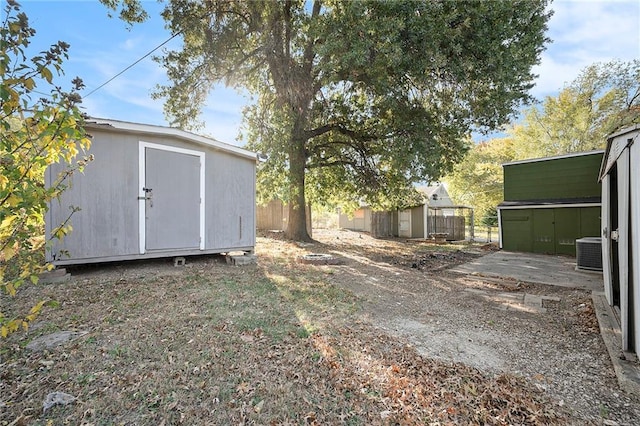 view of yard featuring central AC and a shed