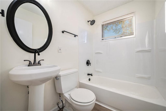 bathroom featuring shower / bath combination and toilet