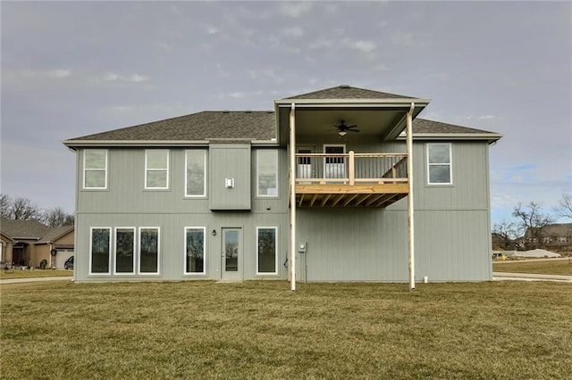 back of house featuring a lawn and ceiling fan