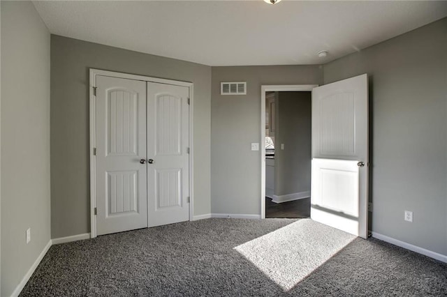 unfurnished bedroom with visible vents, baseboards, a closet, and carpet flooring