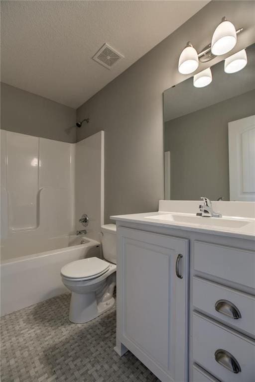 full bathroom featuring visible vents, shower / washtub combination, toilet, vanity, and a textured ceiling