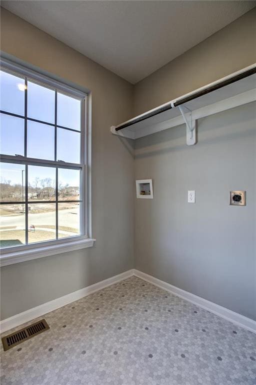 laundry area featuring laundry area, baseboards, visible vents, and hookup for an electric dryer