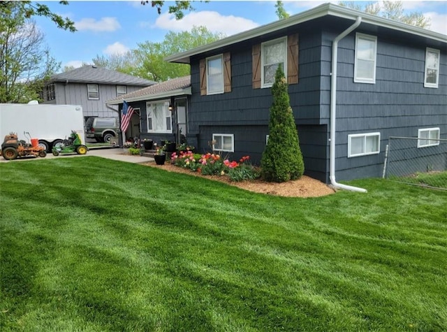 rear view of property with a lawn