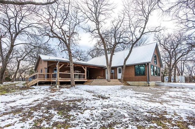 snow covered house with a porch