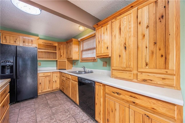 kitchen with black appliances, sink, and a textured ceiling