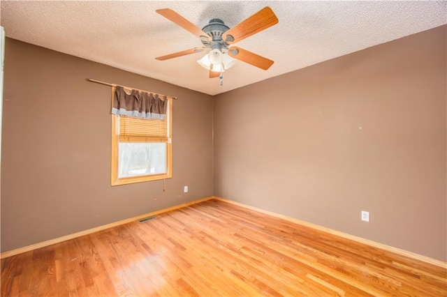 unfurnished room featuring hardwood / wood-style flooring, a textured ceiling, and ceiling fan