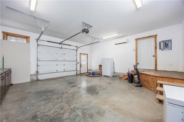 garage featuring electric panel, a wall unit AC, white fridge, and a garage door opener