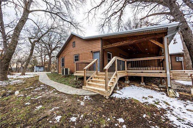 view of snowy exterior featuring a deck