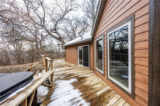 wooden deck featuring a hot tub