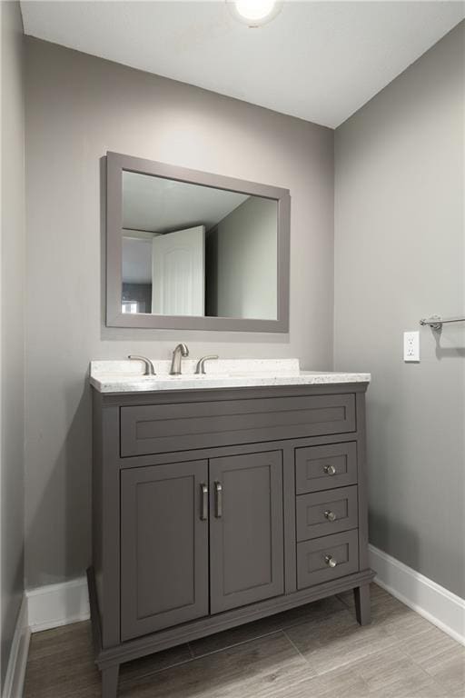 bathroom with vanity and wood-type flooring