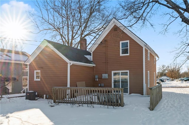 snow covered property featuring central AC unit