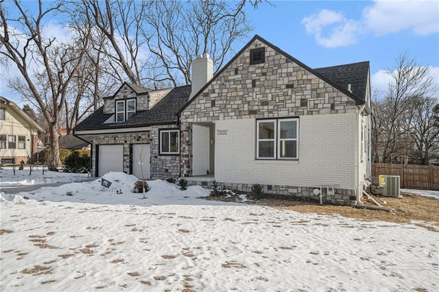 view of front of property with a garage and cooling unit