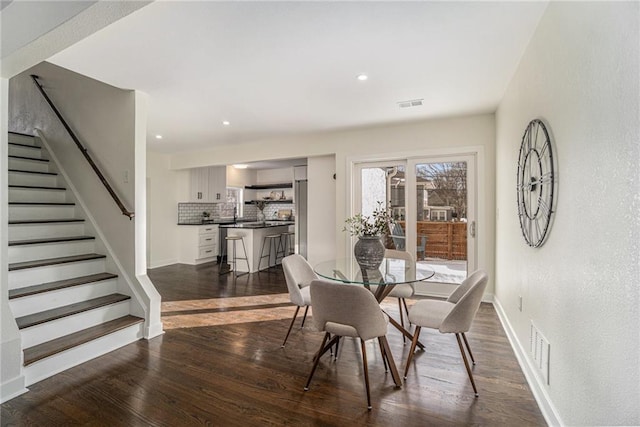 dining room with dark hardwood / wood-style flooring