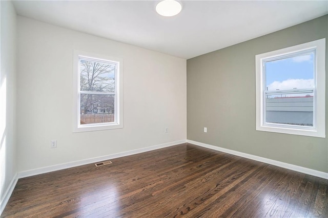 spare room featuring dark hardwood / wood-style floors