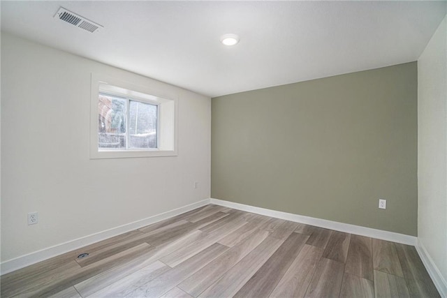 spare room with light hardwood / wood-style floors