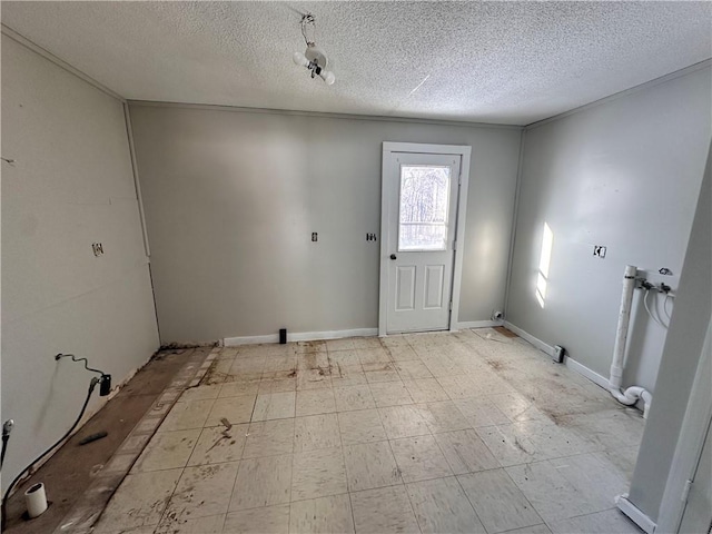 foyer entrance with a textured ceiling