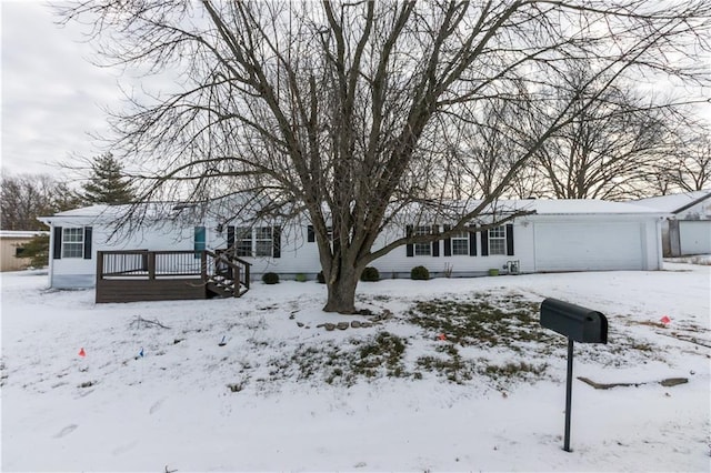 view of front of house with a deck and a garage